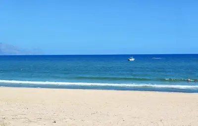 a boat in the water on a beach at 3 Bedroom Stunning Apartment In Alcamo in Alcamo