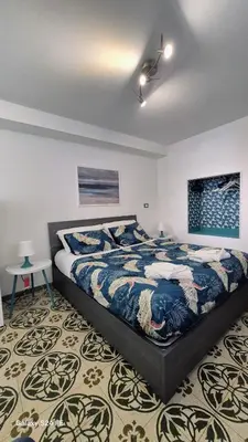 a bedroom with a large bed with two tables at Studio Bandiera in Palermo