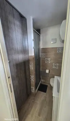a small bathroom with a shower and a toilet at Studio Bandiera in Palermo