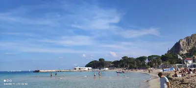 a group of people on a beach in the water at palermo cloister dream house in Palermo