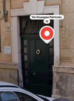 a green door with a red and white sign on it at Casabra in Palermo