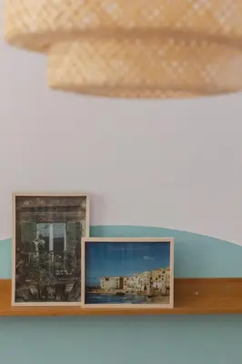 two framed photographs on a shelf in a room at Casabra in Palermo