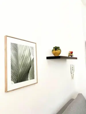a mirror hanging on a white wall in a room at Sicily Apartment 1 - BLUE WAVES in Campofelice di Roccella