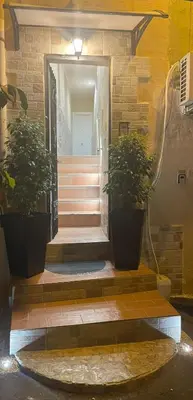 a stairway with two potted plants in front of a building at La Casetta di Lussy in Palermo