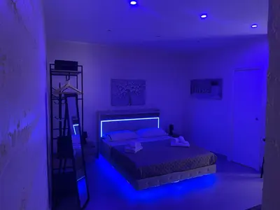 a purple bedroom with a bed and a ladder at La Casetta di Lussy in Palermo