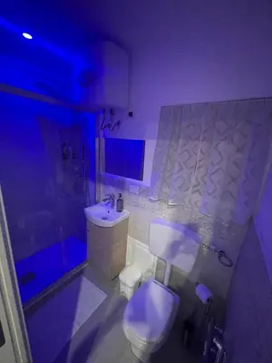 a bathroom with a white toilet and a sink at La Casetta di Lussy in Palermo