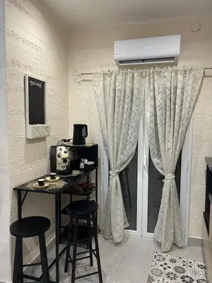 a room with a table and chairs and a window at La Casetta di Lussy in Palermo