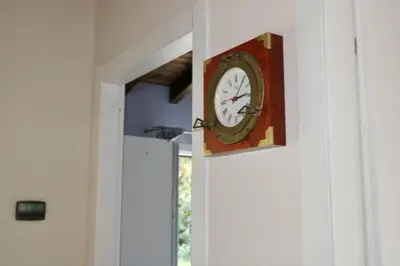 a clock on the wall of a door at Villa Enza Bellissima villa con piscina in Terrasini