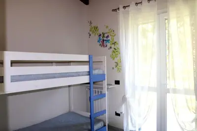 a bedroom with a bunk bed and a window at Villa Enza Bellissima villa con piscina in Terrasini