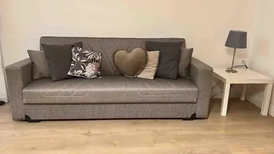 a gray couch with pillows on it in a living room at Villa Marea Mondello in Palermo