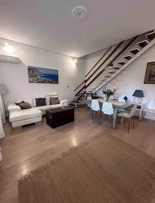 a living room with a couch and a table at Villa Marea Mondello in Palermo