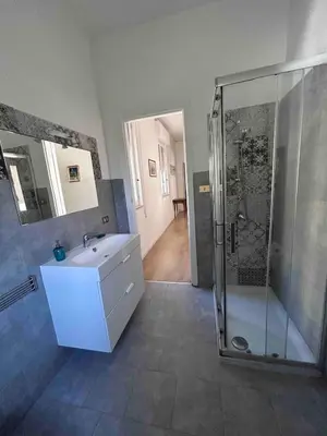a bathroom with a shower and a sink and a toilet at Villa Marea Mondello in Palermo
