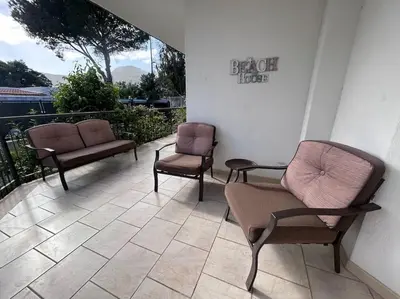 three chairs sitting on a balcony with a view at Villa Mia Mondello, 200m to beach, private parking in Palermo