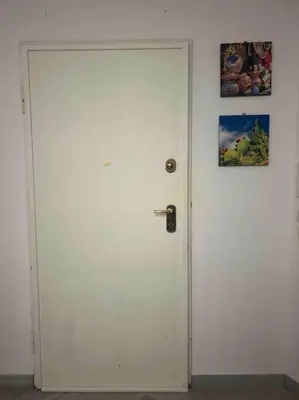 a white door in a room with a picture on the wall at Villa Mia Mondello, 200m to beach, private parking in Palermo