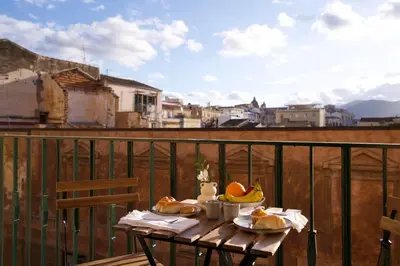 a table with fruit on top of a balcony at Casa Disìu in Palermo
