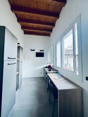 a kitchen with white walls and a wooden ceiling at Guest House Colonna apt in Palermo