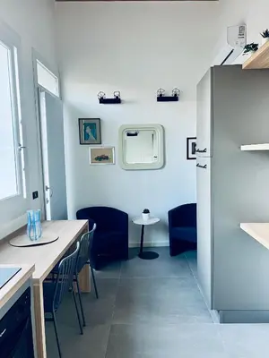 a kitchen with a refrigerator and a table and chairs at Guest House Colonna apt in Palermo
