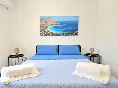 a bedroom with a bed with a view of the ocean at Villa Valentina in Altavilla Milicia