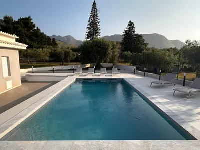 a large swimming pool with lounge chairs at Villa Valentina in Altavilla Milicia