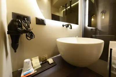 a bathroom with a white sink in a room at Di fronte a Suite in Palermo