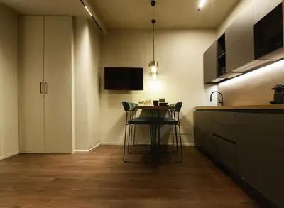 a kitchen with a small table in a room at Di fronte a Suite in Palermo