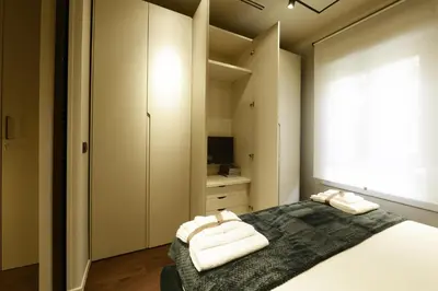 a bedroom with a bed with two towels on it at Di fronte a Suite in Palermo