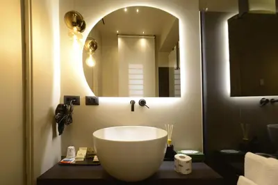 a bathroom with a large white sink and a mirror at Di fronte a Suite in Palermo