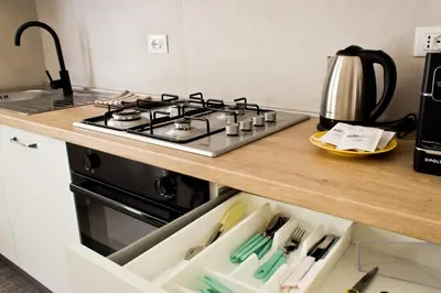 a kitchen with a stove and a counter top at Verdeacqua Home in Castellammare del Golfo