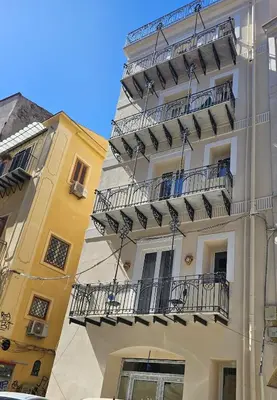 a tall building with balconies on the side of it at Nika Palermo Holiday House in Palermo