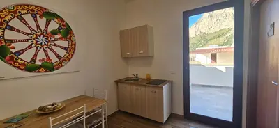 a kitchen with a dart board on the wall at Profumi di Sicilia in Cinisi