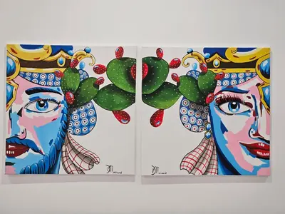 three books with portraits of women and a cactus at Profumi di Sicilia in Cinisi