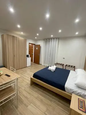a bedroom with a large bed with a blue blanket at Profumi di Sicilia in Cinisi