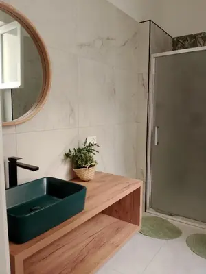 a bathroom with a green sink and a shower at Le case di Caterina in Palermo