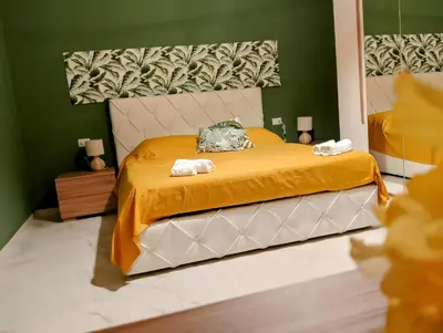 a bedroom with a bed with two towels on it at Le case di Caterina in Palermo