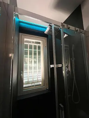 a bathroom with a window and a shower at Cocciu D'Amuri Apartment in Palermo