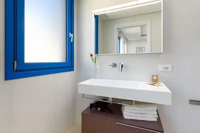 a bathroom with a white sink and a mirror at Residence Mazzini in San Vito lo Capo