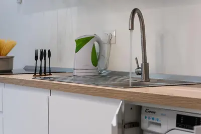a kitchen counter with a sink and a mixer at Residence Mazzini in San Vito lo Capo