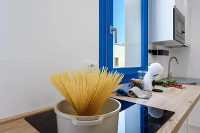 a kitchen with a bucket of spaghetti on a counter at Residence Mazzini in San Vito lo Capo