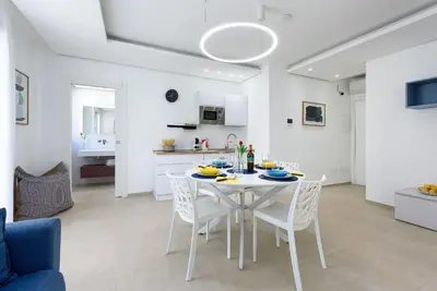 a dining room and kitchen with a table and chairs at Residence Mazzini in San Vito lo Capo