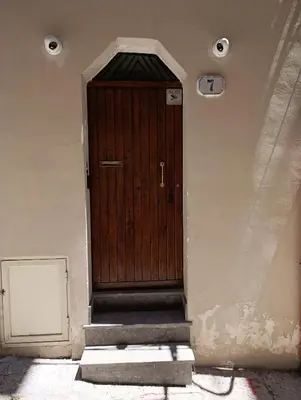 a wooden door on the side of a building at Cala Peppa Apartments in Palermo