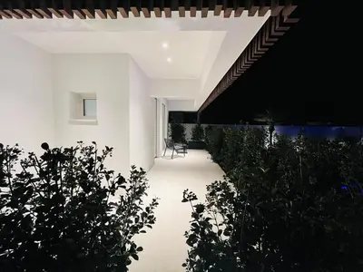 an external view of a house with a garden at Marina Boutique Rooms in Carini