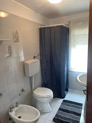 a bathroom with a toilet and a sink at La Via Del Mare in Partinico