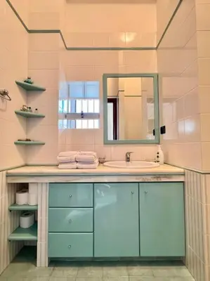 a bathroom with a sink and a mirror at Maison Lume in Castellammare del Golfo