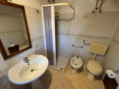 a bathroom with a sink and a shower and a toilet at Maison Lume in Castellammare del Golfo