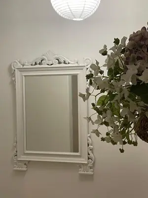 a mirror on a wall with a plant next to it at Casa dei nonni di Yuri in Palermo