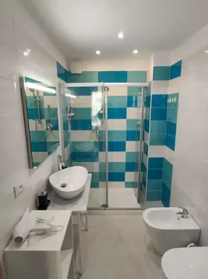 a bathroom with two sinks and a shower at Casa3Fratelli, via Cutino 16 in Isola delle Femmine