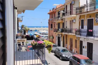 a view from a balcony of a street with cars at Casa3Fratelli, via Cutino 16 in Isola delle Femmine