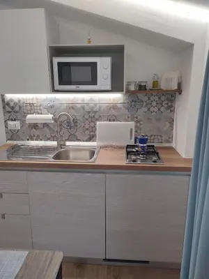 a kitchen with a sink and a microwave at DH Studio Apartments in Castellammare del Golfo