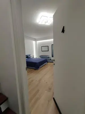 a bedroom with a blue bed in a room at DH Studio Apartments in Castellammare del Golfo