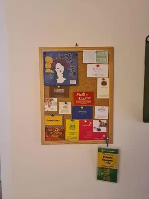 a bulletin board with signs on a wall at Casa e Putia Apartment in Palermo